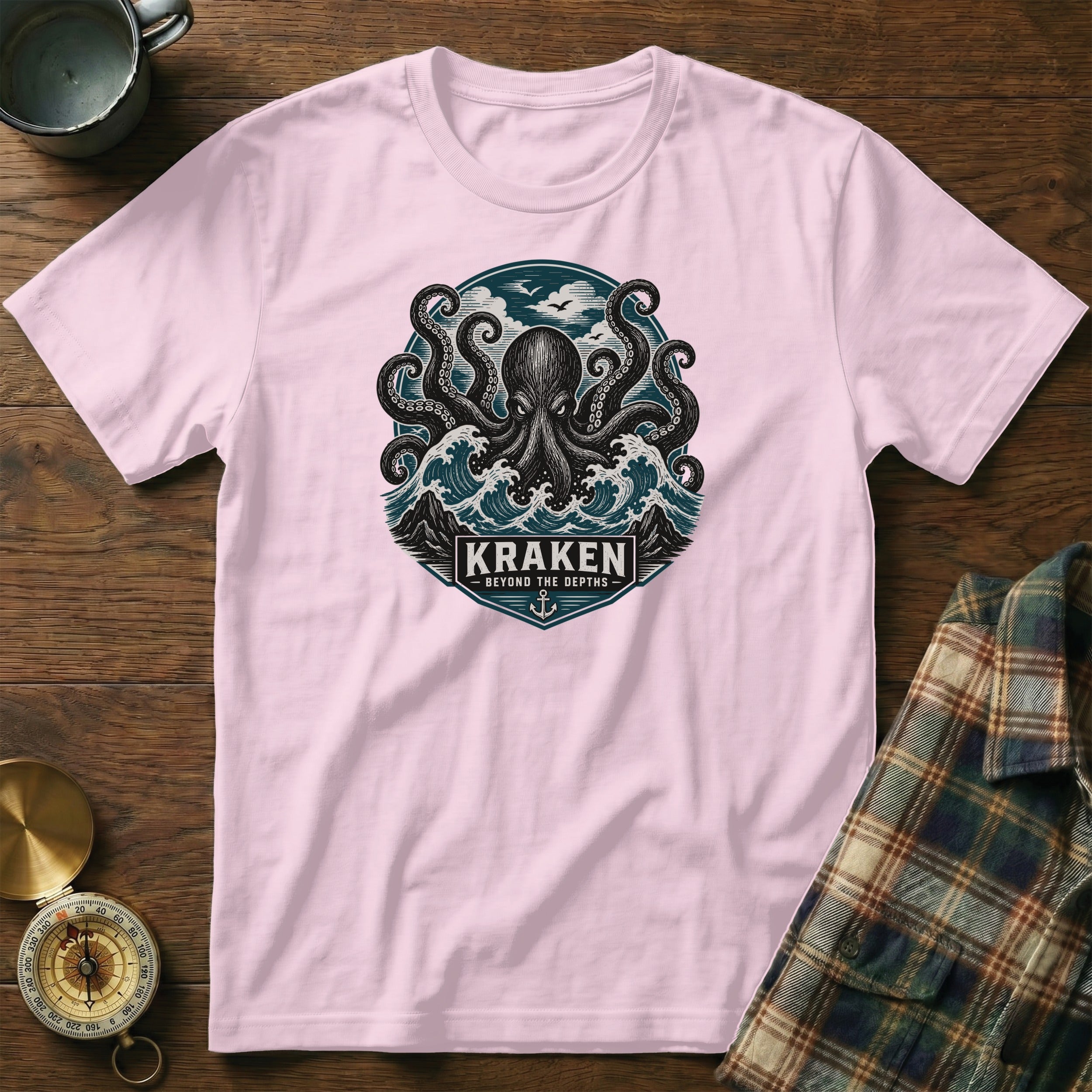 Pink t-shirt with Kraken octopus graphic featuring waves and text "KRAKEN BEYOND THE DEPTHS".