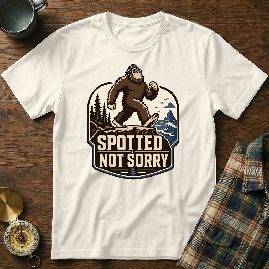 Bigfoot wearing sunglasses walks on rocks with text "SPOTTED NOT SORRY".