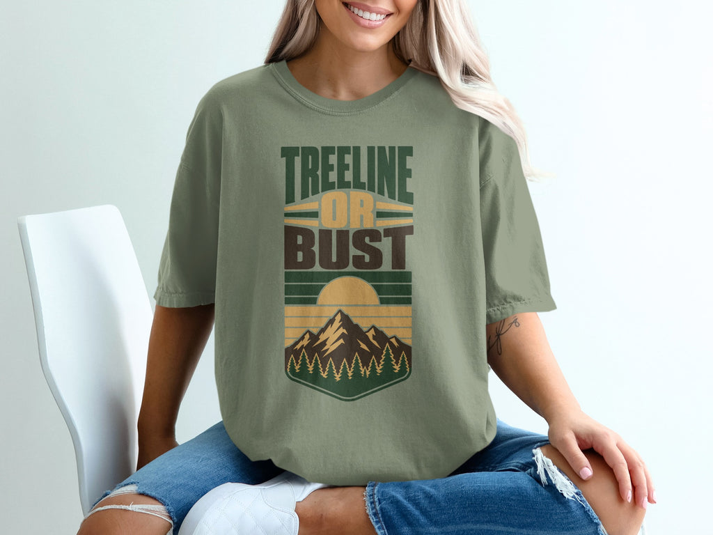 Green t-shirt with "Treeline or Bust" graphic featuring mountains and trees.