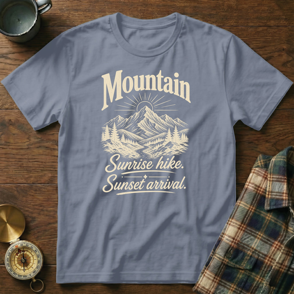 Blue t-shirt featuring a mountain graphic and the text Mountain Sunrise hike, Sunset arrival.