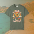 green  t-shirt Retro 70s-style graphic t-shirt featuring a running, happy cartoon sun in sneakers under a rainbow and clouds. The slogan reads: "TODAY'S GOOD MOOD SPONSORED BY DOG WALKS."