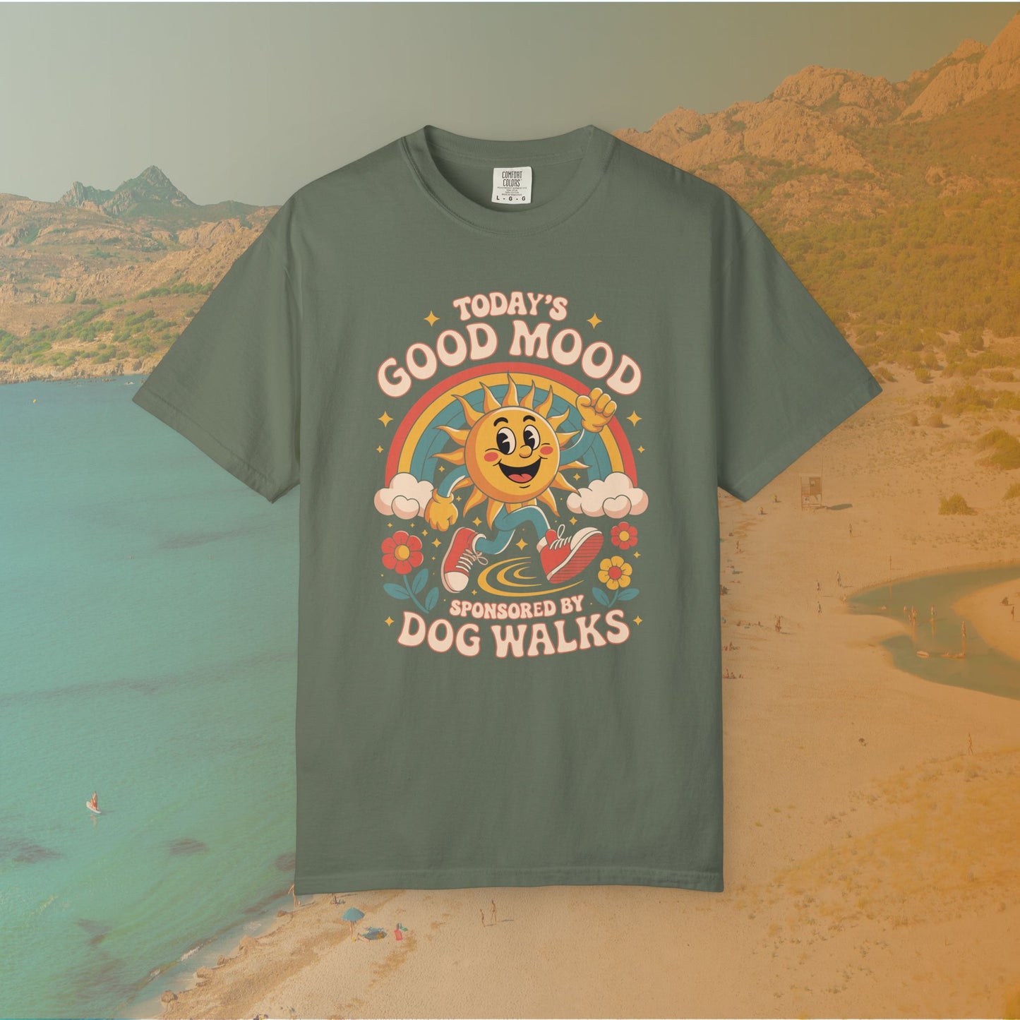 green  t-shirt Retro 70s-style graphic t-shirt featuring a running, happy cartoon sun in sneakers under a rainbow and clouds. The slogan reads: "TODAY'S GOOD MOOD SPONSORED BY DOG WALKS."