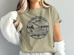 Tan t-shirt with "Guarding the Chips Loosely" text and beach scene graphic.