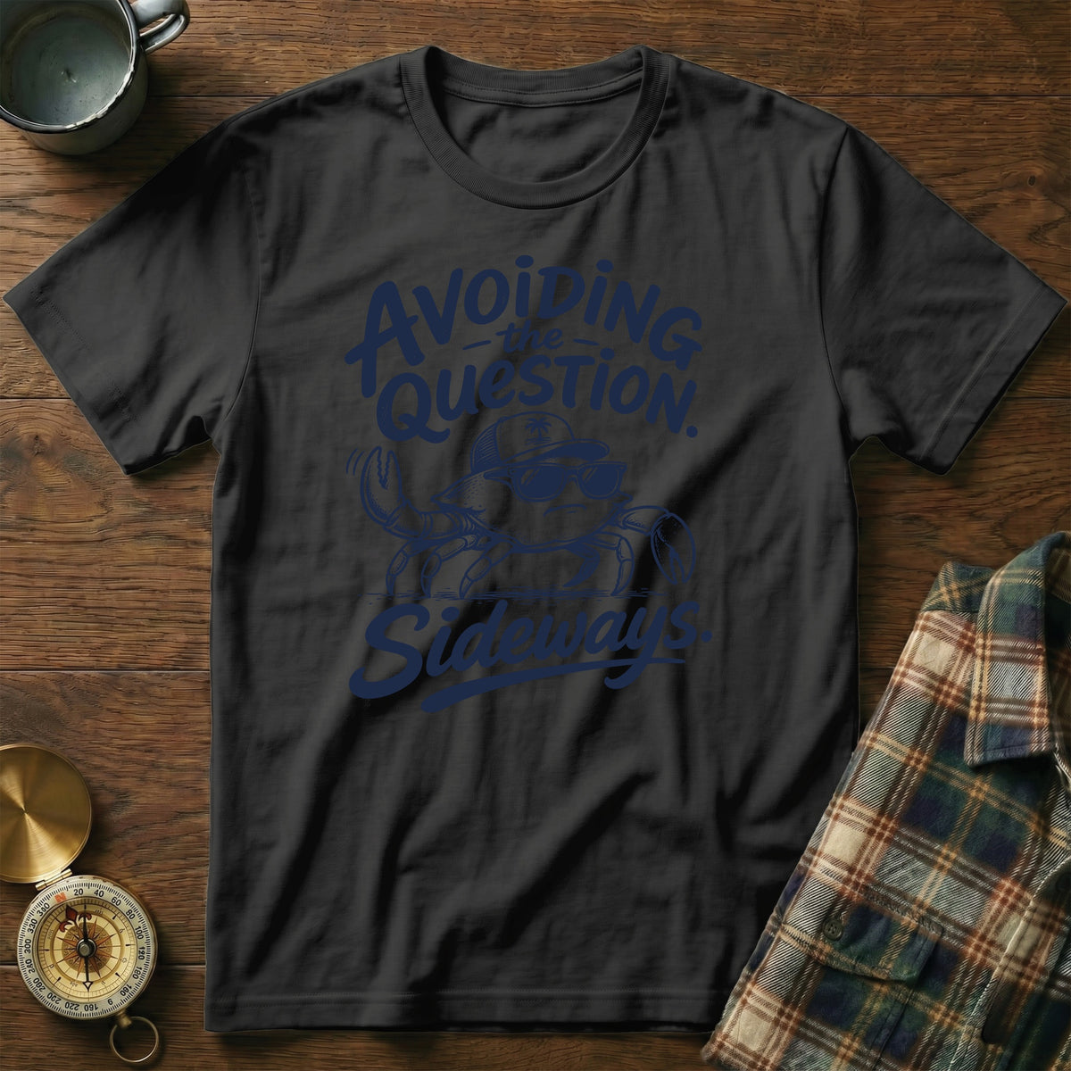 Black crewneck t-shirt featuring a blue graphic of a crab wearing sunglasses and a cap, accompanied by the text Avoiding the question sideways.