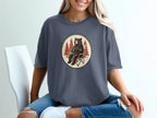 Bear sitting in camp chair holding coffee mug with pine trees in background.