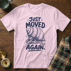 Pink t-shirt with a sketch of a sad hermit crab and text "JUST MOVED AGAIN."