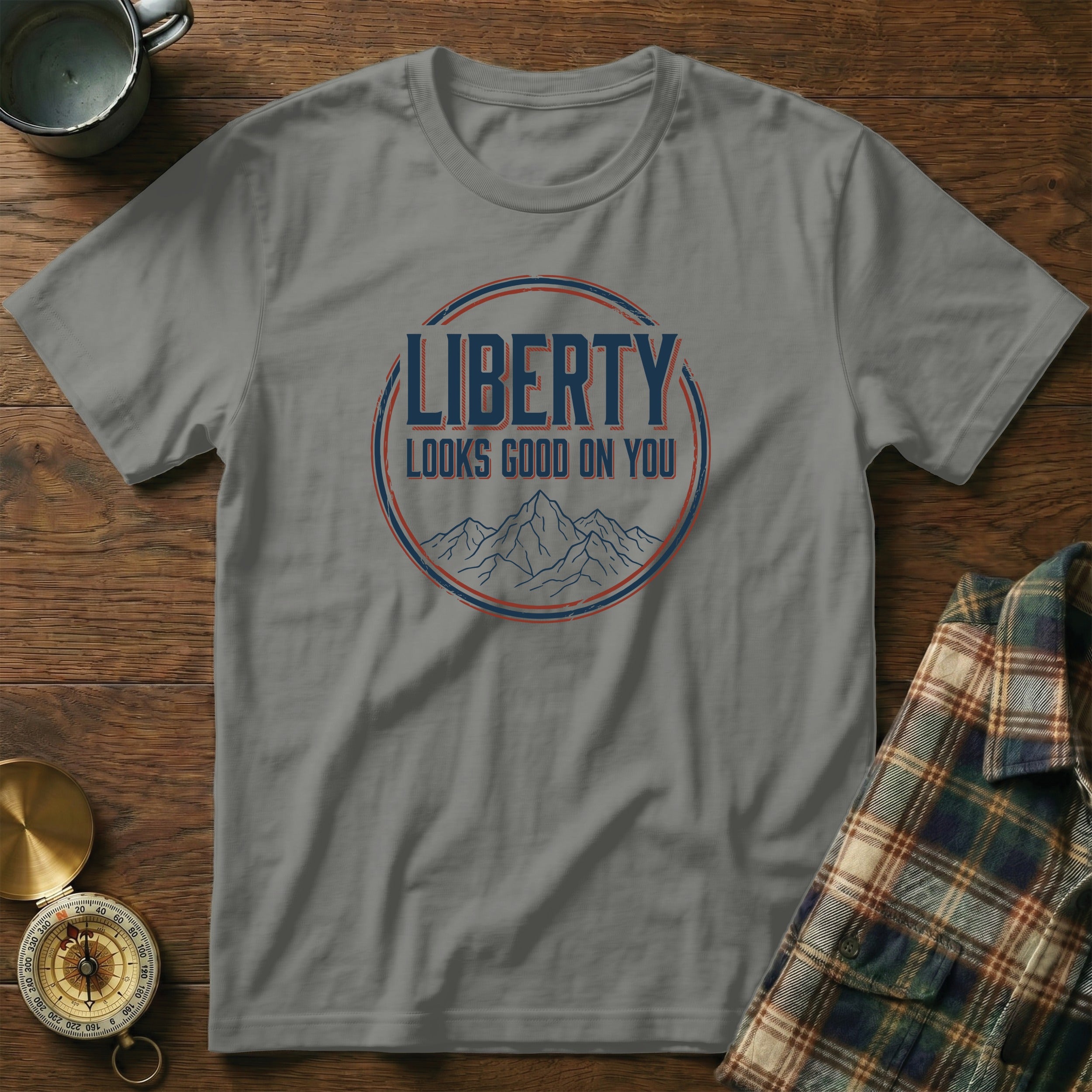 Grey t-shirt with "LIBERTY LOOKS GOOD ON YOU" text and mountain graphic.