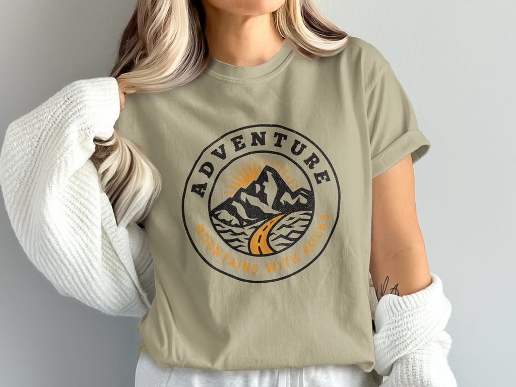 T-shirt with circular mountain and road design, reads "Adventure Mountains with Rocks".