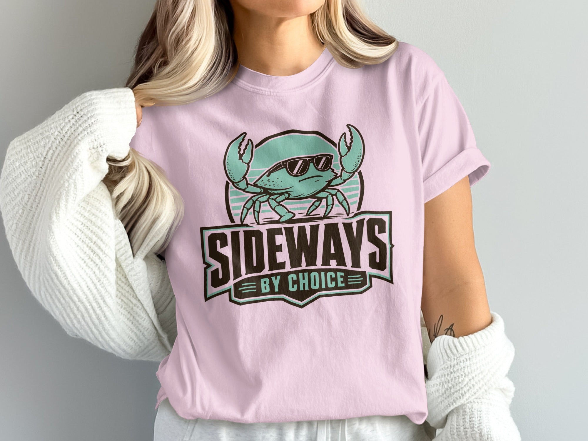 Pink t-shirt with a graphic of a crab wearing sunglasses and text reading "SIDEWAYS BY CHOICE".
