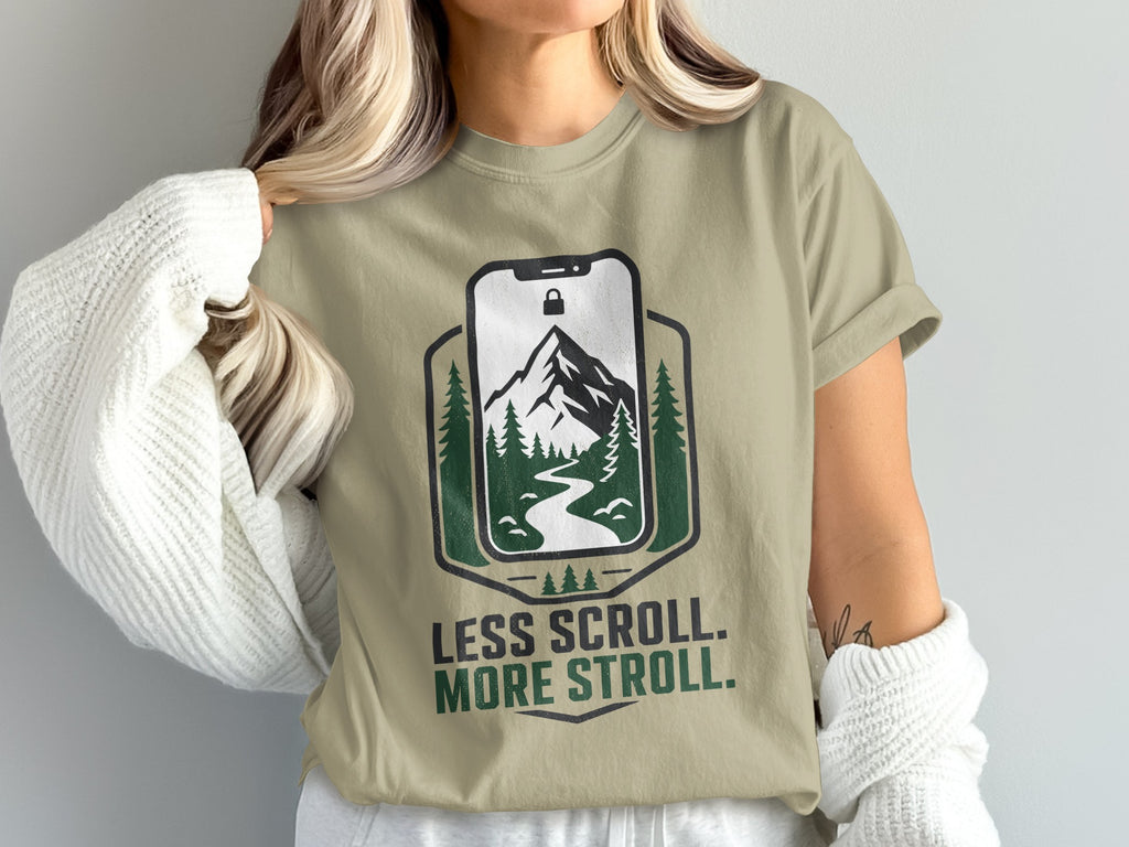 T-shirt with phone graphic, mountain, river, trees, and text "LESS SCROLL. MORE STROLL."