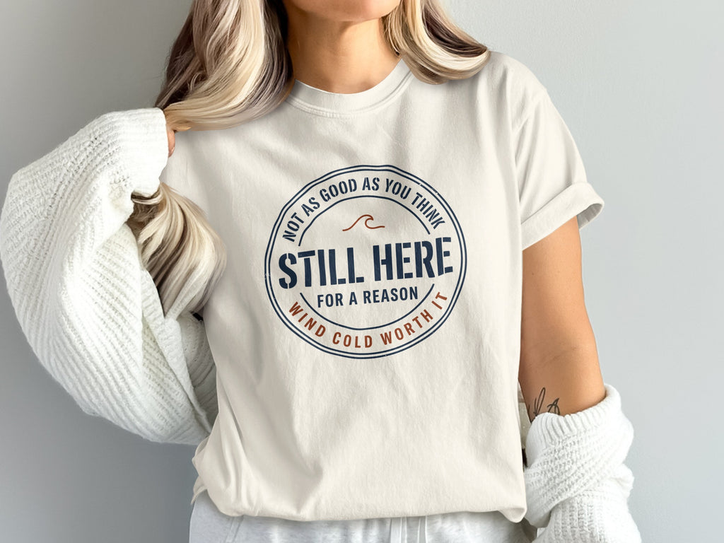 Cream t-shirt with circular graphic reading "Still Here For A Reason" and "Not As Good As You Think".