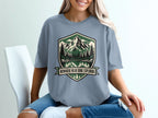 T-shirt with a mountain lake scene and text "Nowhere Near Done Exploring".