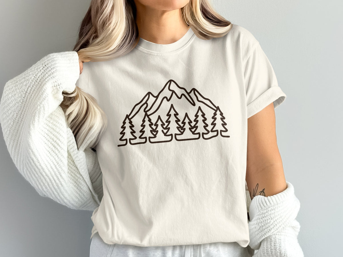 Cream t-shirt with a minimalist mountain and pine tree outline design.