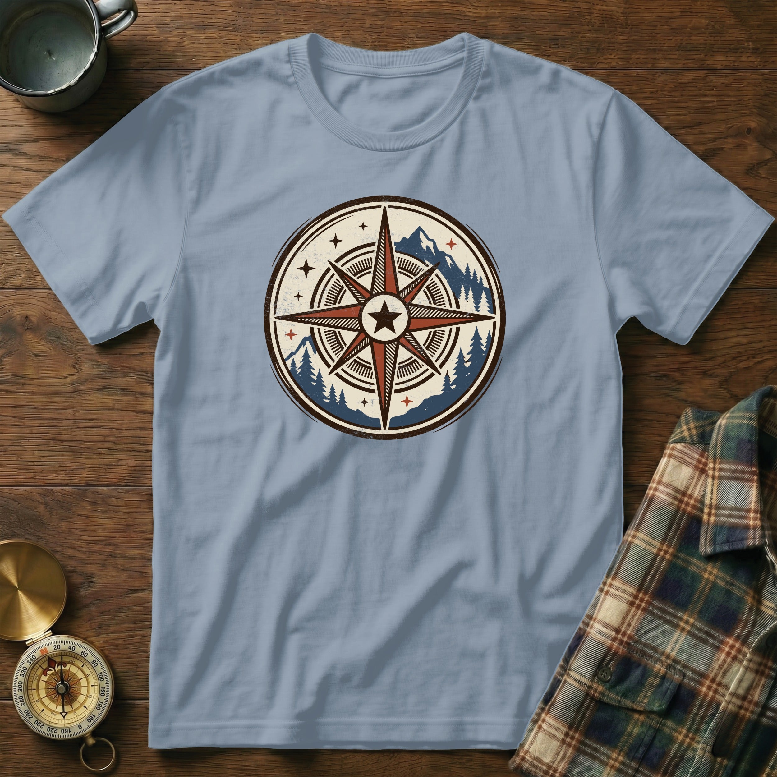 Light blue t-shirt with a vintage compass and mountain graphic.