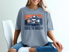 T-shirt with cassette tape graphic featuring mountains, sun, and text "Chase the Horizon".