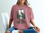 Pink t-shirt with "Less Scroll. More Stroll." text and a mountain scene within a phone graphic.
