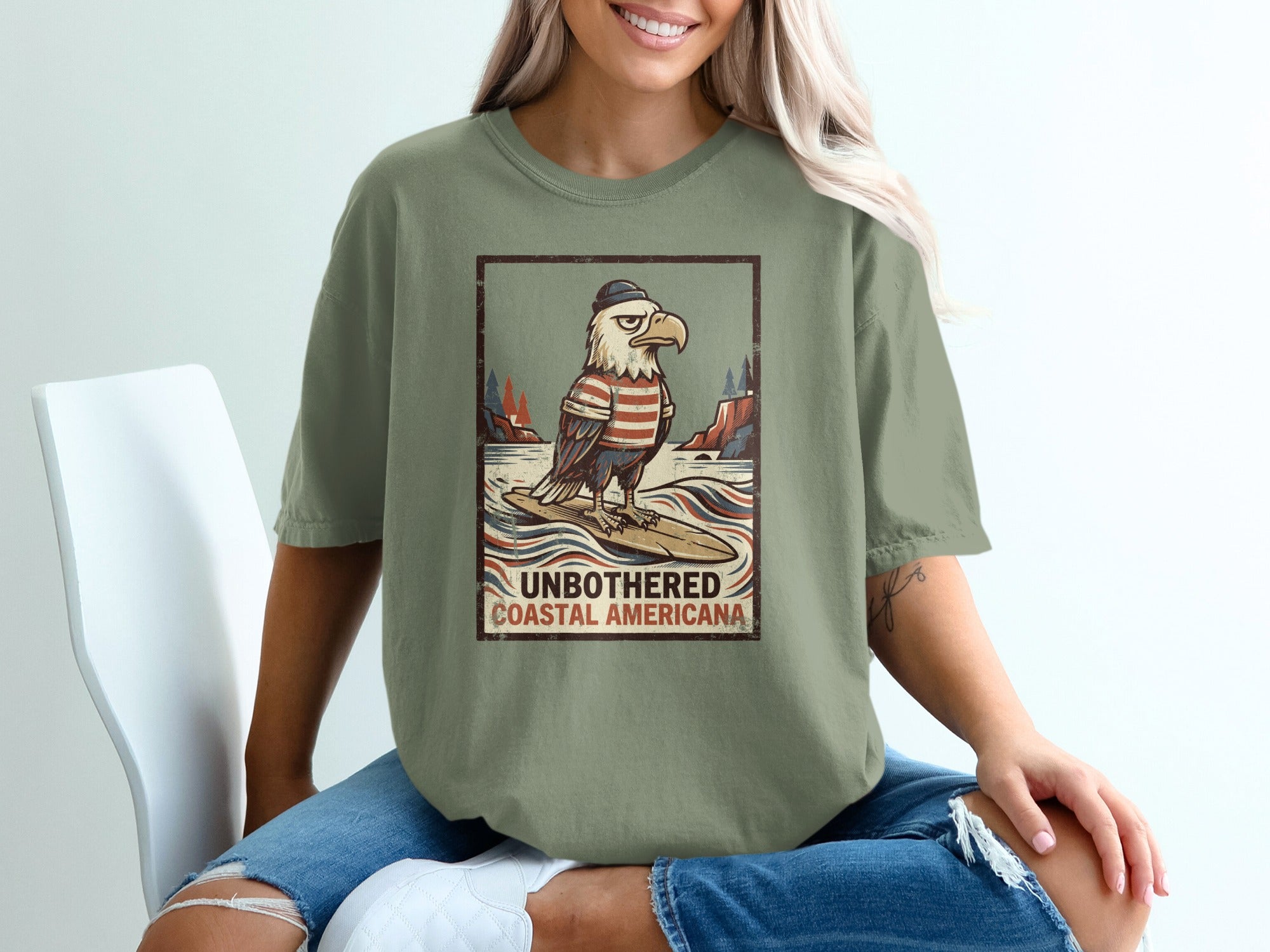Graphic of eagle surfing with text "UNBOTHERED COASTAL AMERICANA".