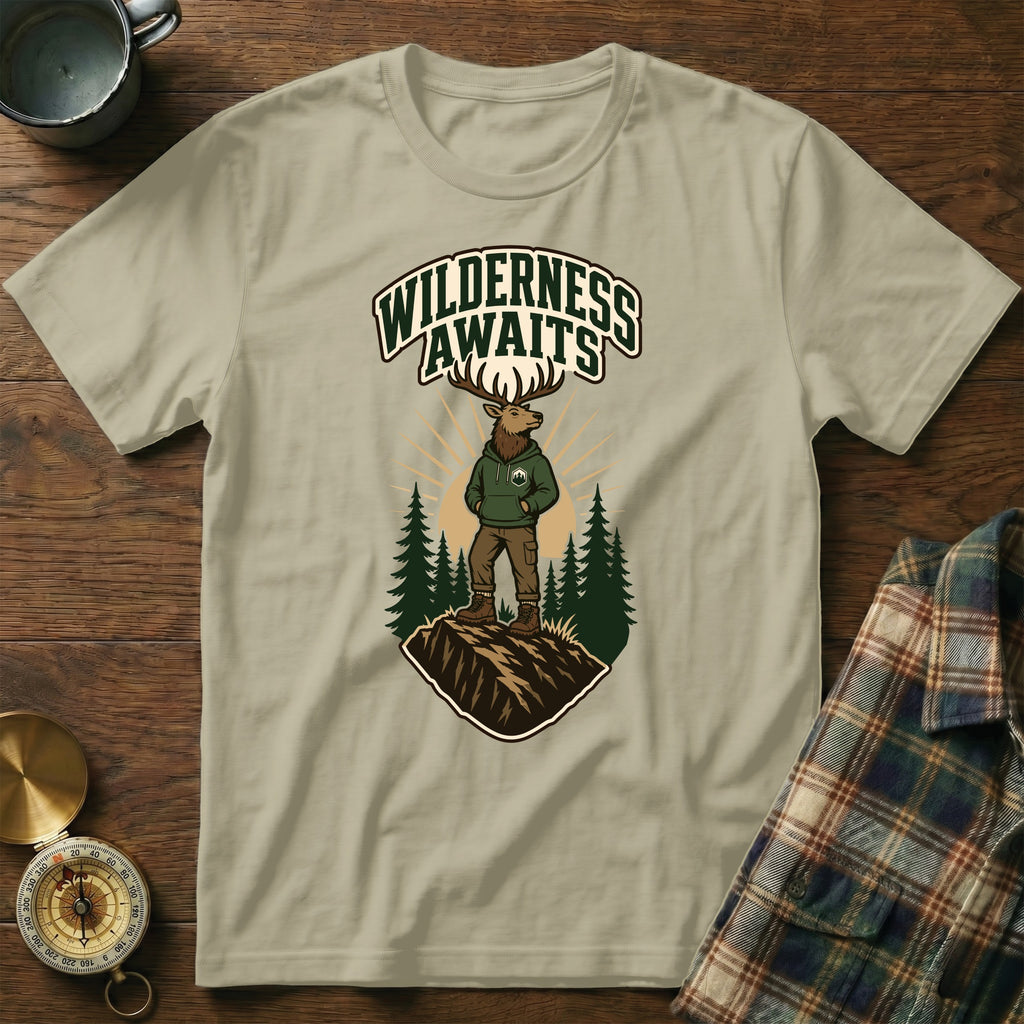 T-shirt graphic of elk wearing hoodie, "Wilderness Awaits" text, pine trees.