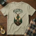 T-shirt graphic of elk wearing hoodie, "Wilderness Awaits" text, pine trees.