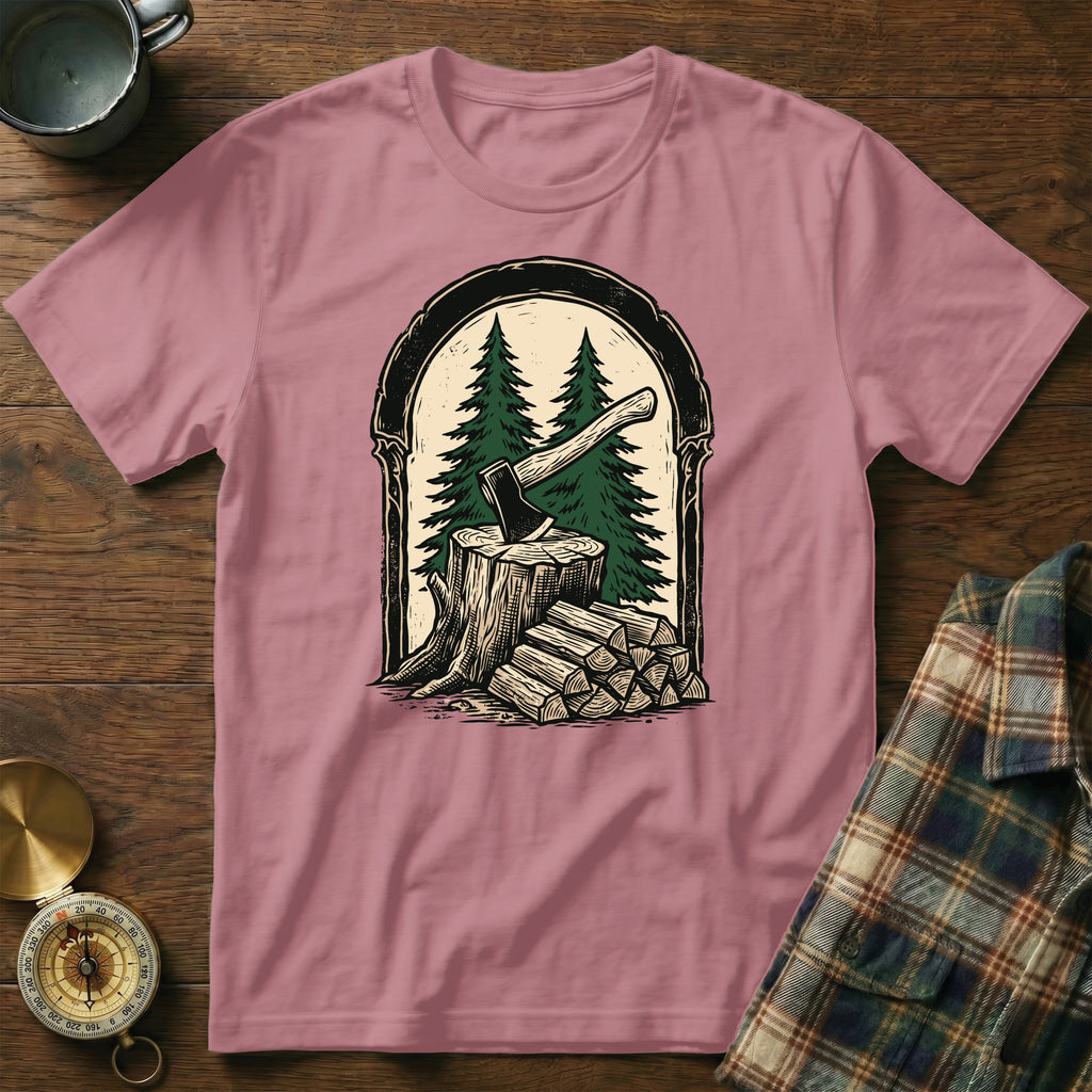 T-shirt featuring an axe in a tree stump with firewood and pine trees.