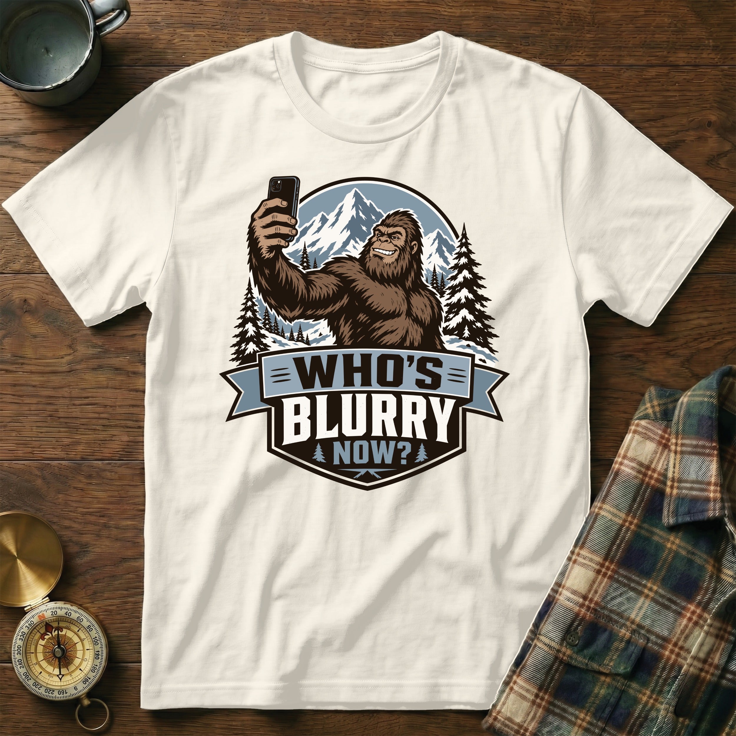 Bigfoot taking a selfie in the mountains with text "WHO'S BLURRY NOW?".