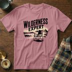 Pink t-shirt with "WILDERNESS EXPERT" text and a camping chair illustration.