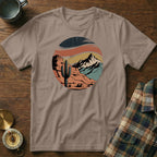 T-shirt featuring desert landscape with cactus, mountains, and sunset design.