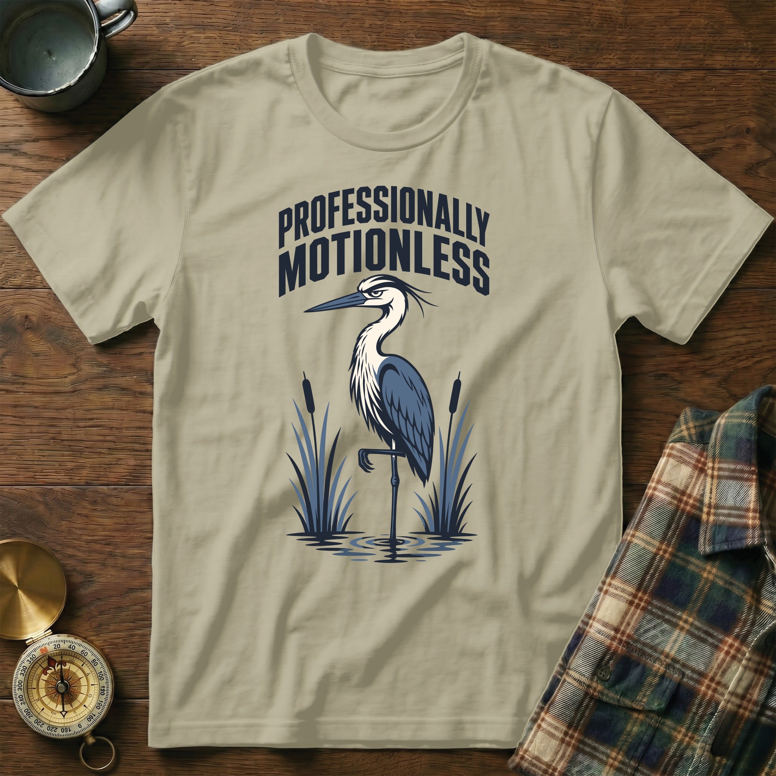 T-shirt with heron graphic and text "Professionally Motionless"