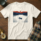 White t-shirt with a minimalist navy and red scene of a canoe on a lake.