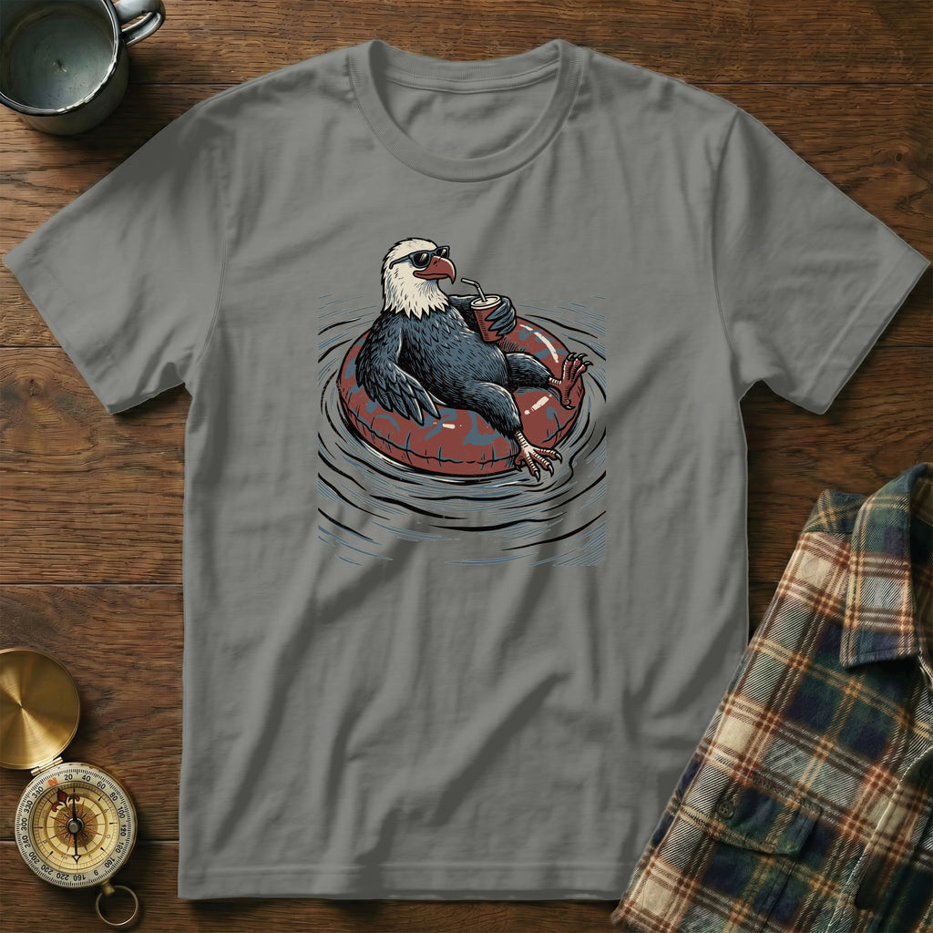 T-shirt with a graphic of a bald eagle relaxing in an inner tube, wearing sunglasses.