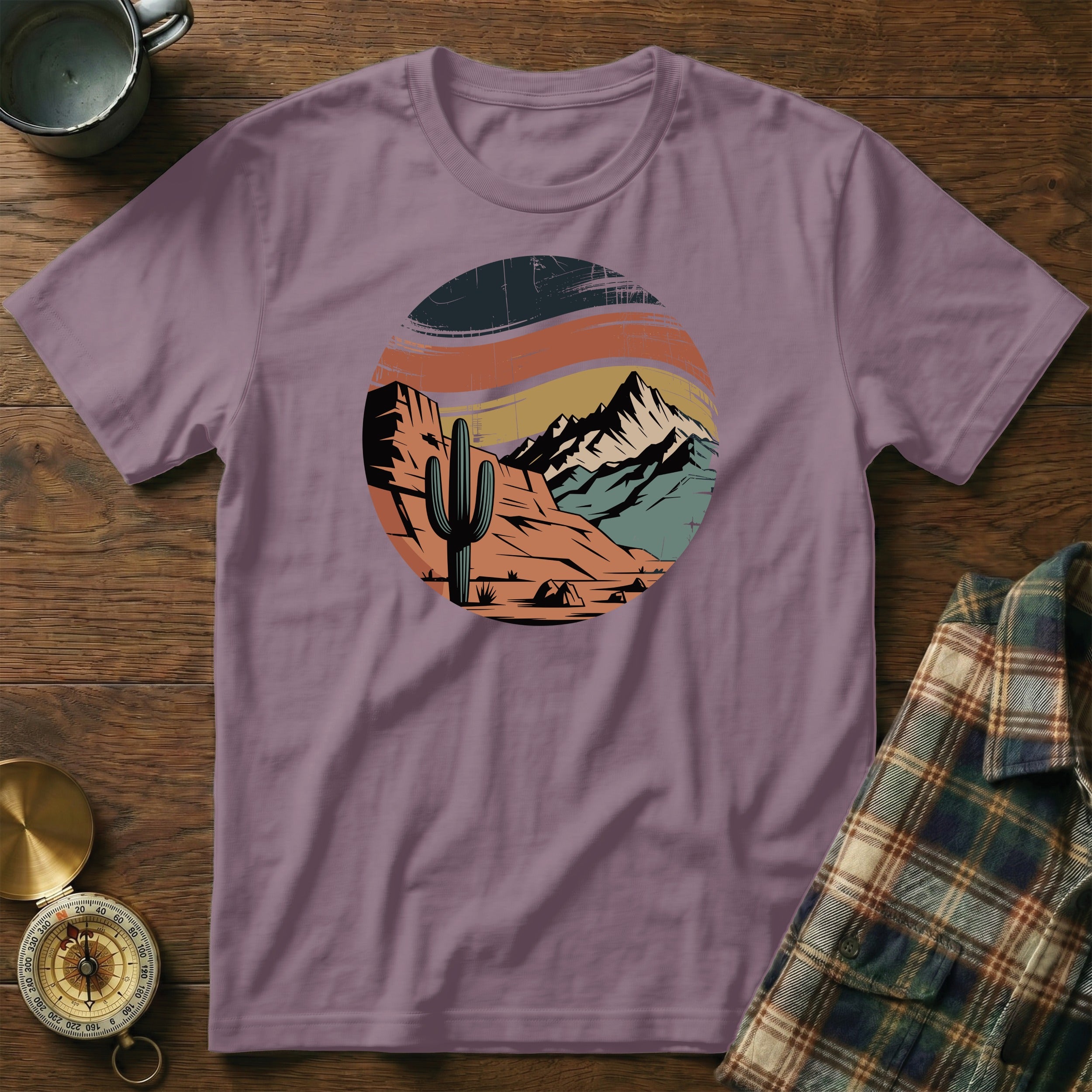 T-shirt with desert landscape featuring cactus, mountains, and tent.