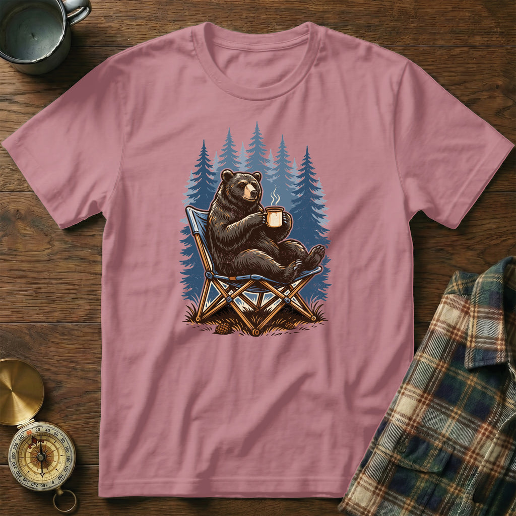 Pink t-shirt with a graphic of a bear sitting in a camp chair drinking coffee.