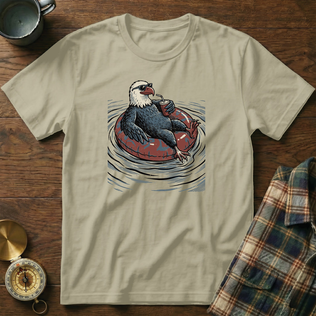 Bald eagle wearing sunglasses floats on inner tube with drink.