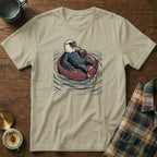 Bald eagle wearing sunglasses floats on inner tube with drink.