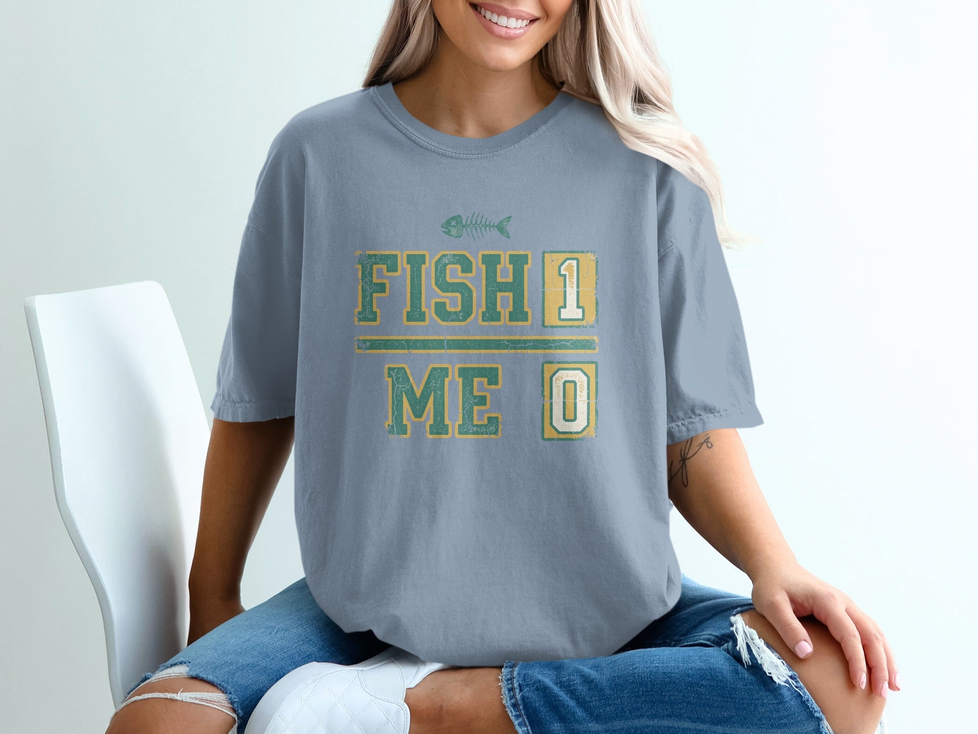 T-shirt with "FISH 1 ME 0" text and fish skeleton graphic.