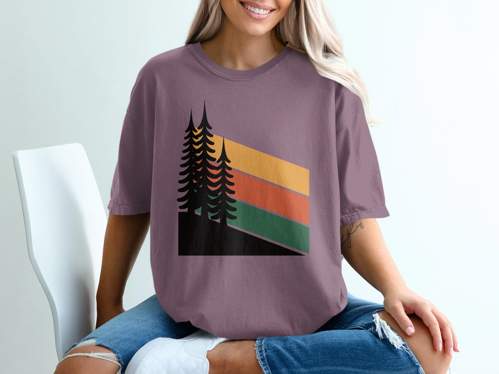 T-shirt with stylized pine trees and abstract mountain stripes.
