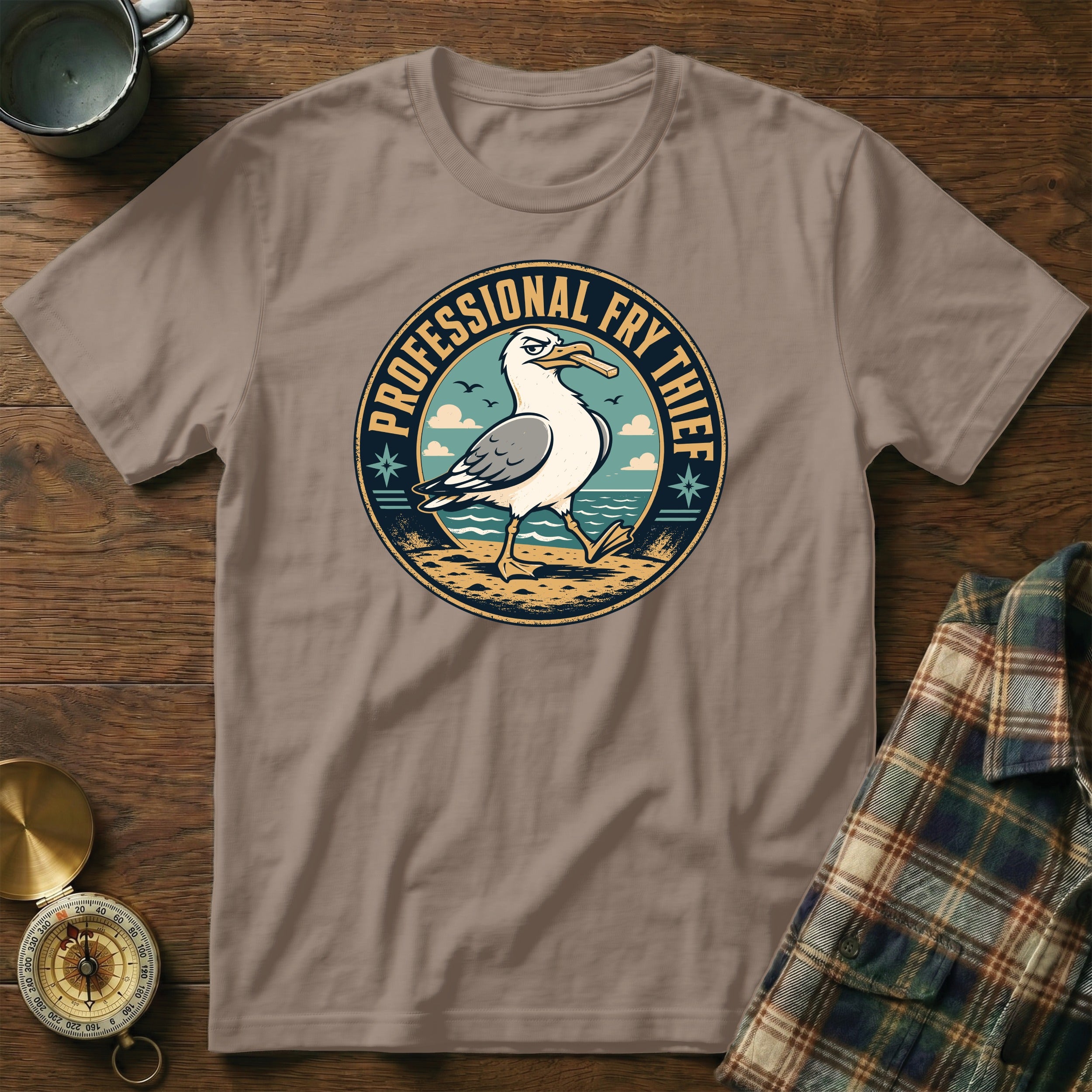 T-shirt with a seagull on a beach with text "PROFESSIONAL FRY THIEF".