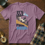 A mauve crewneck t-shirt featuring a graphic of a goat sliding downhill with text saying It's All Downhill From Here.