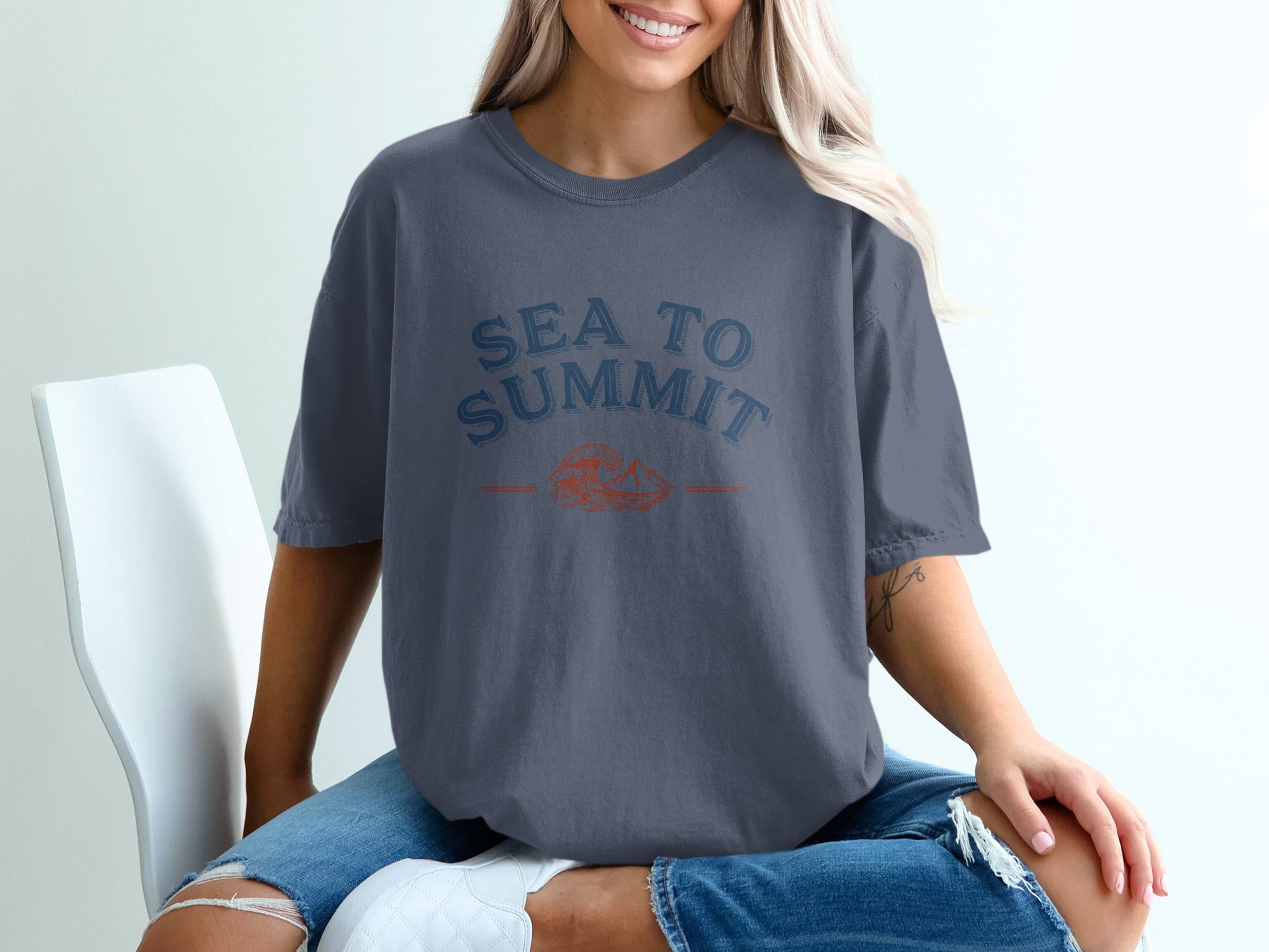 Grey t-shirt with "SEA TO SUMMIT" text and an orange mountain and wave graphic.