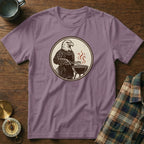 Purple t-shirt with graphic of eagle in apron grilling food.