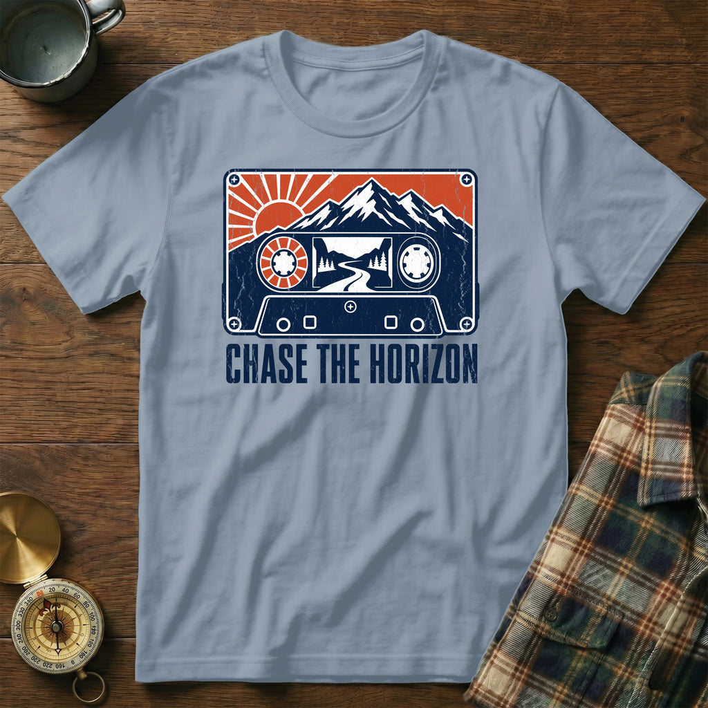 T-shirt with a cassette tape design featuring mountains, sun, and road, and text "Chase the Horizon."