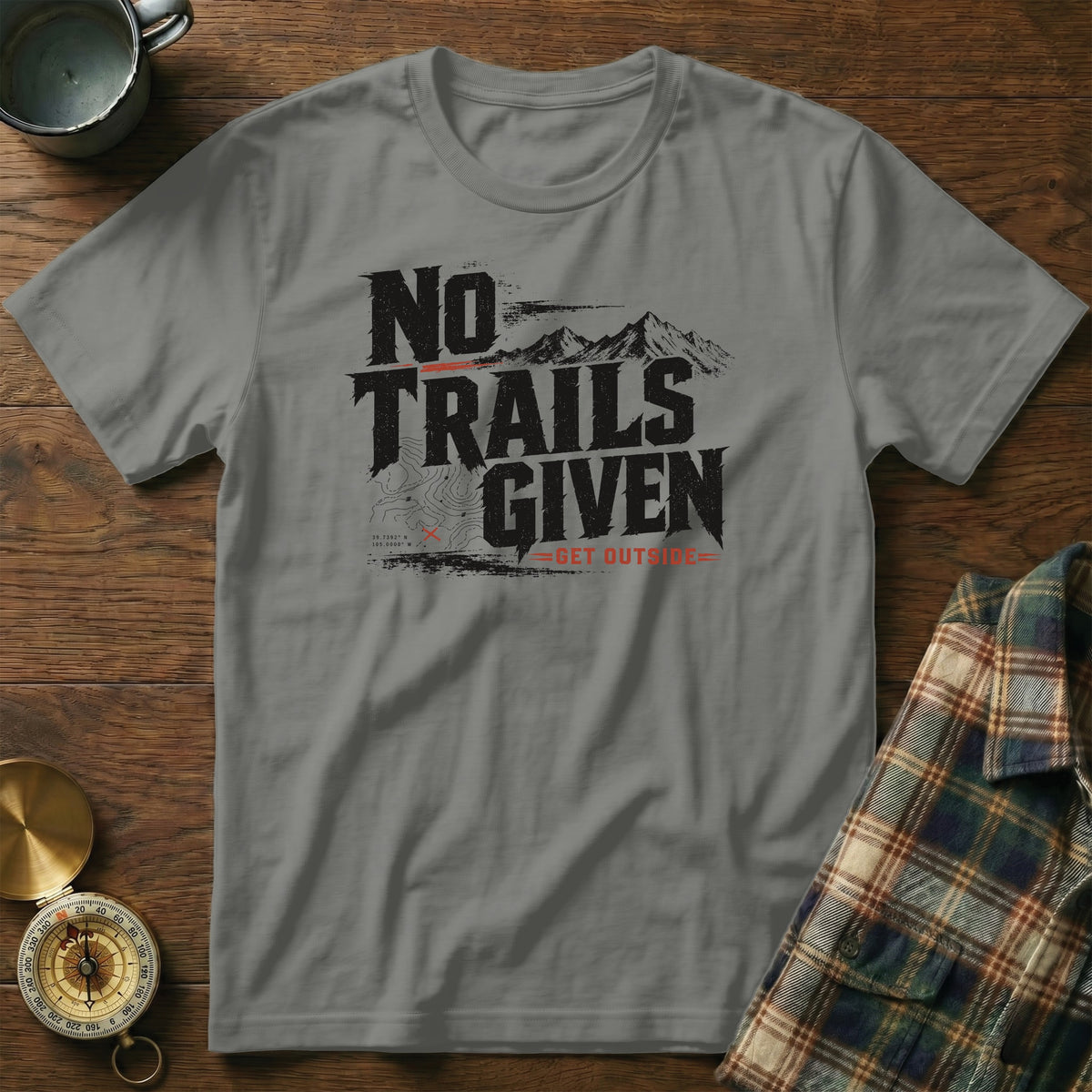 Grey t-shirt with "NO TRAILS GIVEN GET OUTSIDE" text and mountain graphic.