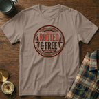 Brown t-shirt with circular "Rooted & Free" graphic and compass and mug accents.