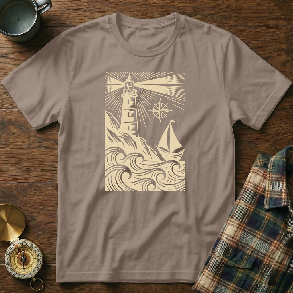 T-shirt featuring a lighthouse, sailboat, and waves design.