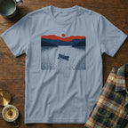 T-shirt with a minimalist landscape of a lake, mountains, and a canoe.