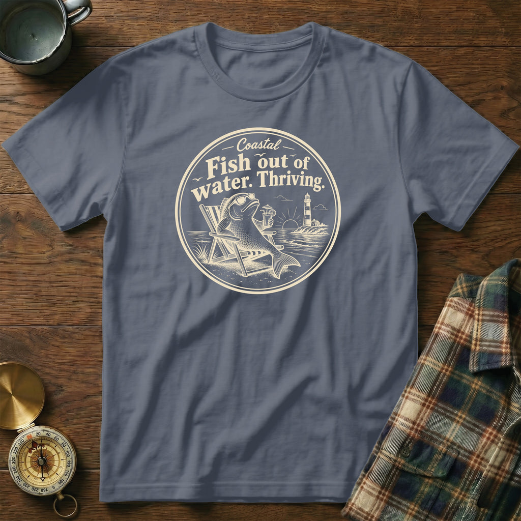 A dark blue crewneck t-shirt featuring a circular graphic with a fish in a beach chair.