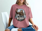 Bigfoot takes a selfie in a winter landscape with the text WHO'S BLURRY NOW?