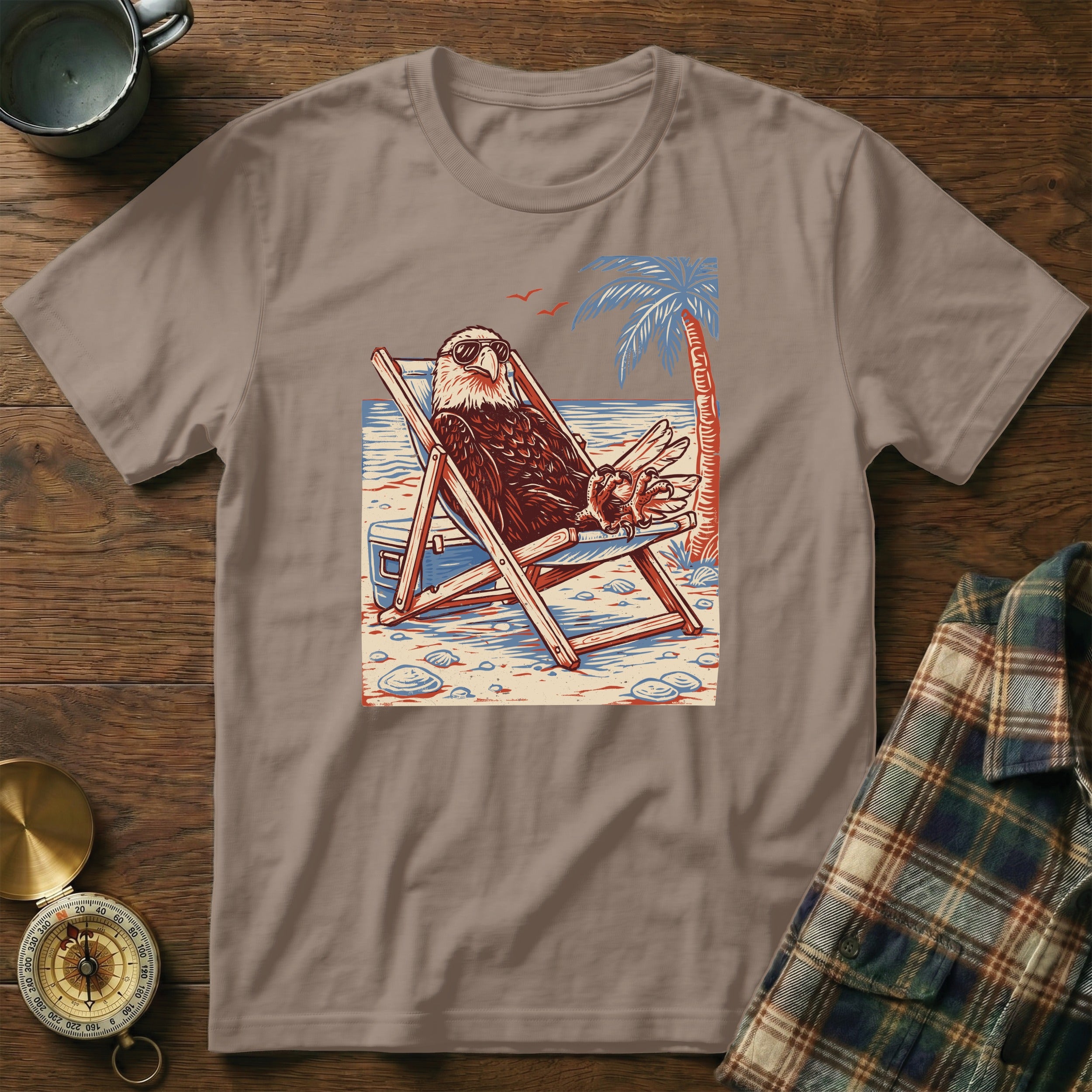 Eagle wearing sunglasses relaxing in a beach chair with a palm tree.