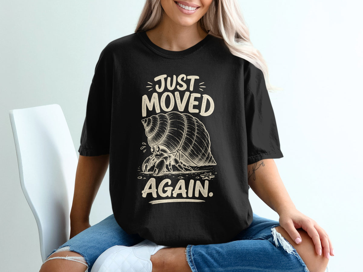 Black t-shirt with graphic of hermit crab and text "JUST MOVED AGAIN."