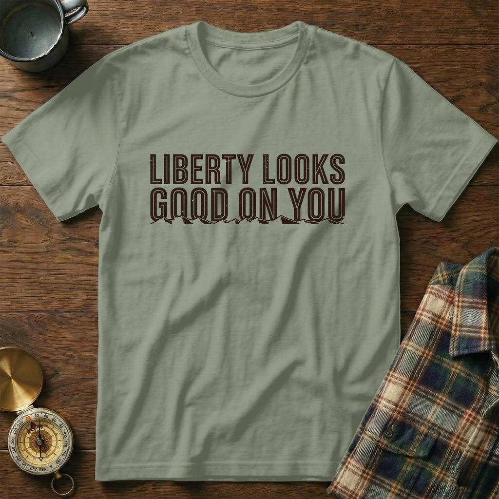 Light green t-shirt with "Liberty Looks Good On You" text and mountain graphic.